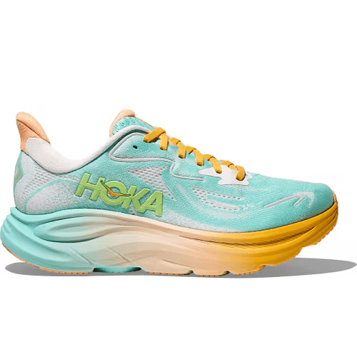 Hoka Clifton 10 Dame løbesko i Blue Spark/White har en tyk, polstret sål, mesh-overdel og hvide snørebånd - ideel til daglig træning. Hoka-logoet pryder siden, og sålen går fra blå ved hælen til hvid ved tåen.