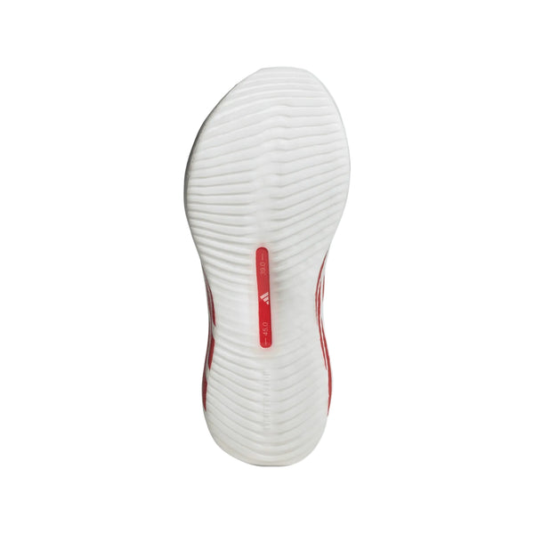 Billedet viser den hvide sål på Adidas Hyperboost Edge, Dame (Cloud White/Pure Ruby/Zero Metalic) med en bølget tekstureret slidbane og et lille rødt rektangel i midten med betegnelsen TORSION SYSTEM.