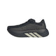 Et sidebillede af Adidas Hyperboost Edge Dame-løbeskoen i farvekombinationen Chacoa/Ntgrey/Alumin x Hermanos Koumori – en sort sportsløbesko med en tyk sål, grå detaljer og tre hvide diagonale striber på mellemsålen – fotograferet på en hvid baggrund. Denne komfortfokuserede landevejsløbesko fra Adidas forener moderne design med enestående ydeevne.