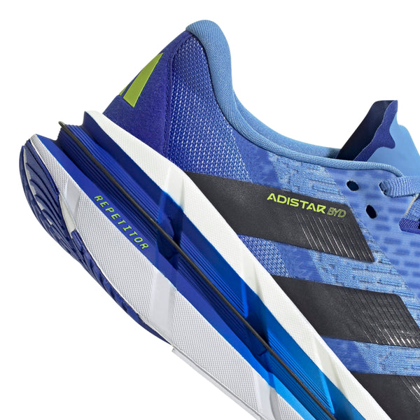 Nærbillede af Adidas Adistar Byd løbesko herre i Blufus/Legink/Sslime viser hælen med "ADISTAR BYD" på siden og "REPETITOR" på sålen, designet til komfort og stabilitet i blå, sort og hvid.