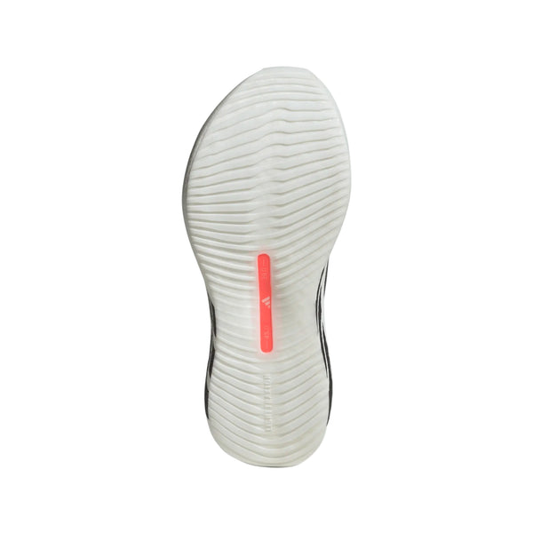 Billedet viser sålen på en hvid Adidas Hyperboost Edge-løbesko (model: Dame, Ftwwht/Auon/Soltur) med et struktureret, bølget mønster og en lodret lyserød stribe med et lille logo i midten. Denne sko, der er designet til komfortfokuseret løb på vej, er fotograferet på en ensfarvet hvid baggrund.
