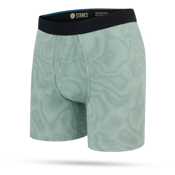 Stance Solid Green Wholester herre boksershorts har et subtilt bølget mønster, sort STANCE-logo linning og frontpose. Vises på en hvid baggrund.