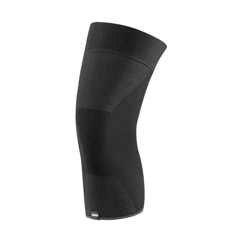 CEP Mid Support Knee Sleeve 2.0, Unisex, i sort, har fremragende kompressionsstøtte og et sømløst design af elastisk ribbet stof, vist på en hvid baggrund.