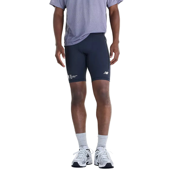 En person har sorte New Balance NYC Marathon RC Pocket Half Tights 9″, Herre, på, hvor løbslogoet er placeret på højre ben.
