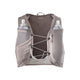 En grå Salomon Gravel Skin 4 Set-drikkevest i farven Iron/Silver Cloud er udstyret med SensiFit-teknologi, der sikrer en optimal pasform, to forlommer med vandflasker, rum med lynlås, justerbare elastiksnore på tværs af brystet og et åndbart rygpanel i mesh – perfekt som en unisex-løbevest til Salomon Gravel Running – vist på en hvid baggrund.