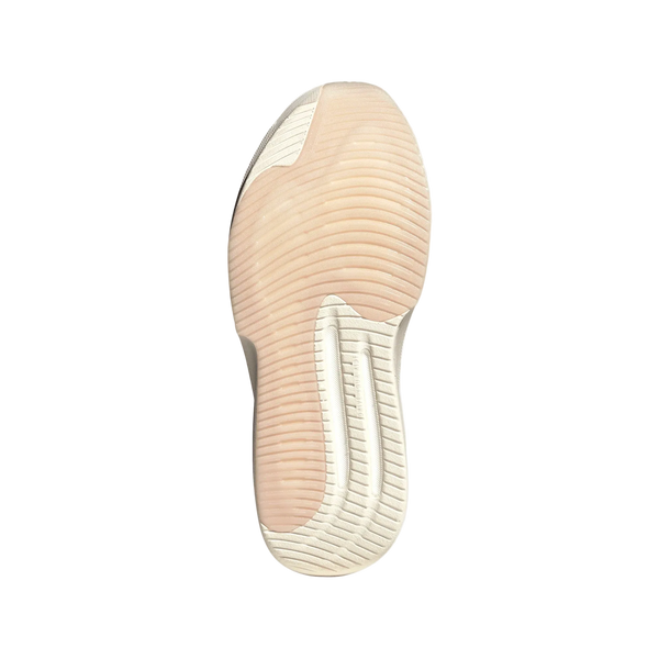 Billedet viser en underside af Adidas Supernova Prima 3, Dame, Wontau/Vagrme/Dualil-løbeskoens sål, der har et bølget, struktureret mønster i lyserøde og off-white nuancer. Den gummiagtige sål er udstyret med den karakteristiske Dreamstrike Pro-mellemsål, der sikrer øget komfort og støtte.