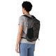 Man ser en person set bagfra med kort, krøllet hår, klædt i en grå T-shirt og blå leggings, der bærer en sort Patagonia Terravia Pack 14L-rygsæk med sorte sidelommer i netstof og en brystrem.