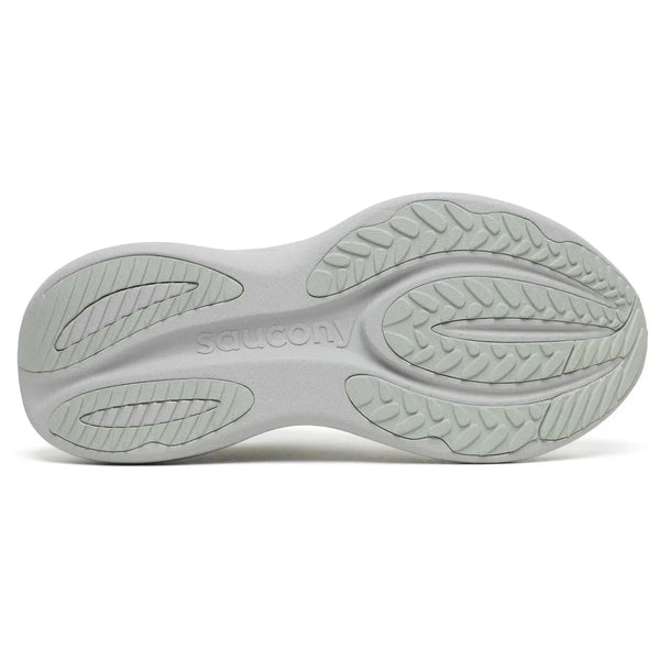 Billedet viser den lysegrå sål på Saucony Triumph 24, Dame, Cast løbesko med en struktureret gummiprofil, buede riller og "saucony" præget i midten. Den er designet til optimal støddæmpning.