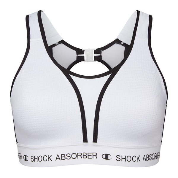 Shock Absorber Ultimate Run Bra Padded, Dame, White har sort kant, racerback-stropper, udskæring foran, lås på ryggen og logoer. Lavet af svedtransporterende materialer for maksimal støtte under aktiviteter med høj belastning.