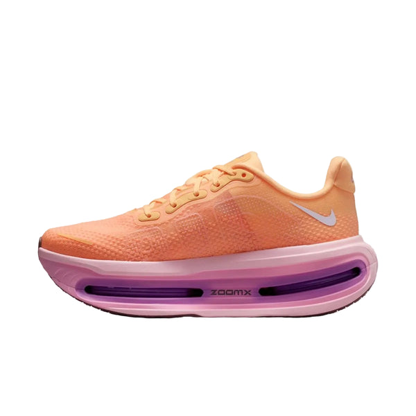 Et sidebillede af Nike Vomero Premium Dame i Tangerine Tint/Tattoo-Bright Crimson med hvidt logo, pink og lilla sål med "zoomx" på mellemsålen, mesh-struktur, snørelukning og responsiv ZoomX-skum for maksimal komfort.