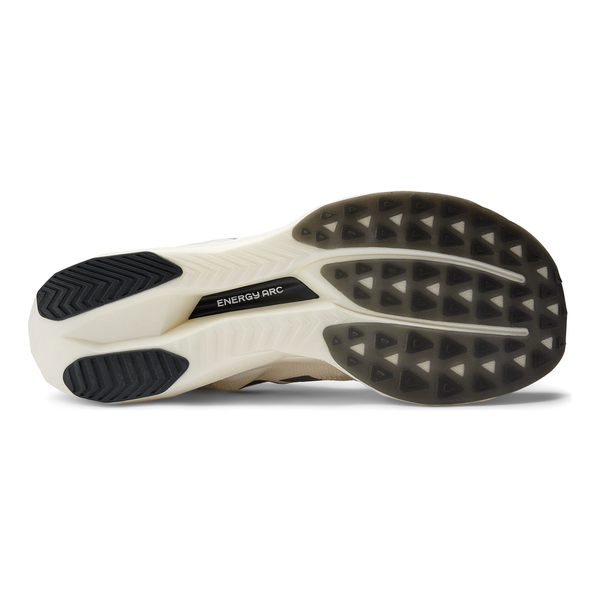 Billedet viser ydersålen på New Balance Fuelcell Supercomp Elite V5, Dame, Linen med et beige og sort slidbanemønster, ENERGY ARC-tekst i midten og flere teksturerede grebzoner.